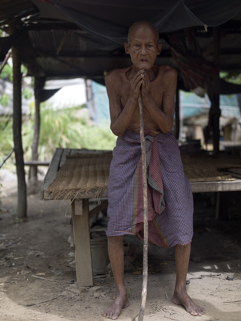 Nou Tab in his 'house' in Cambodia, elderly man with no income or health care